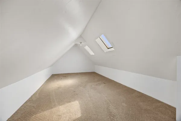 an empty room with a empty space and windows