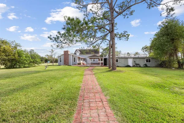 a swimming pool with outdoor seating and yard