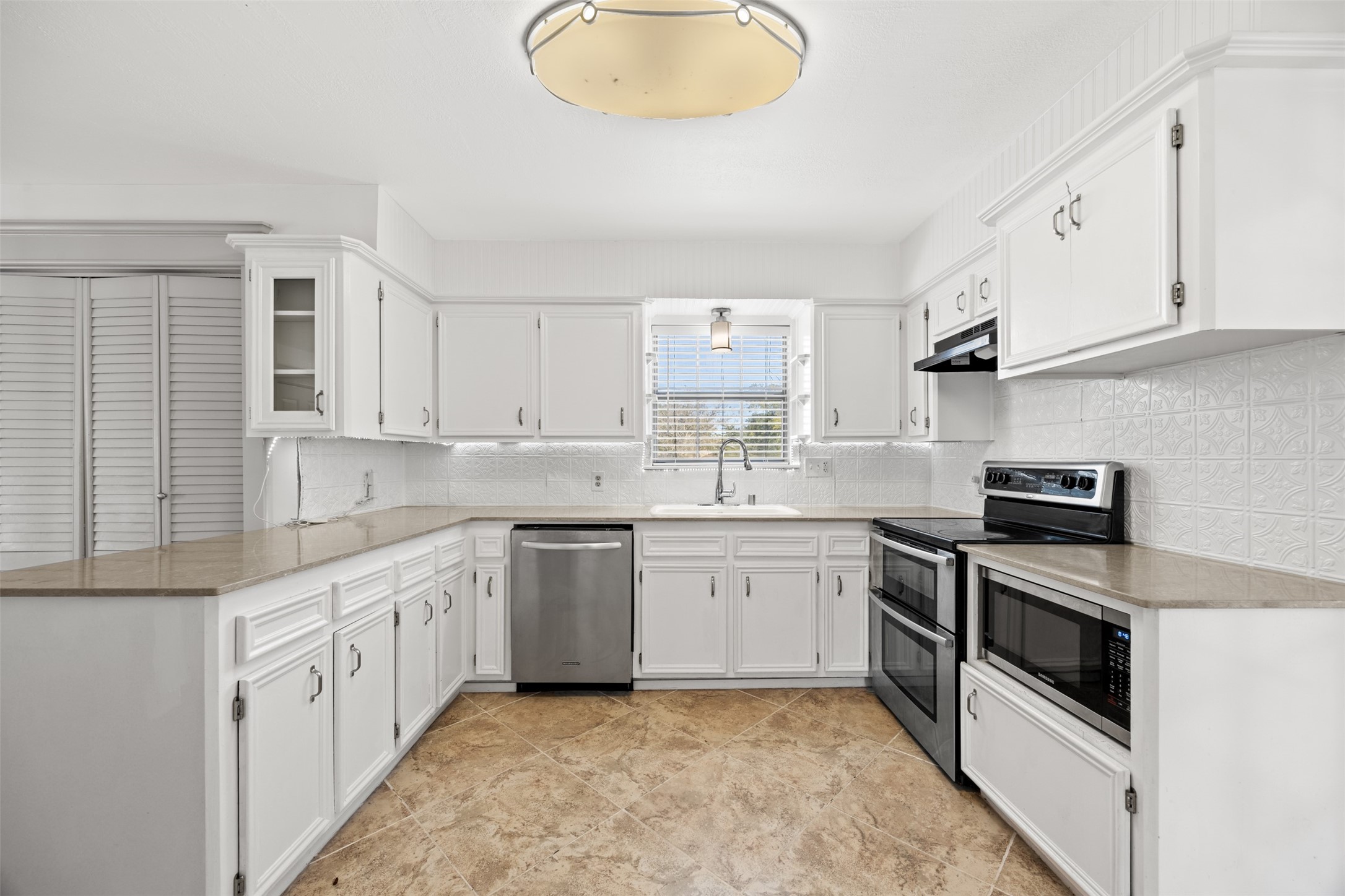 4910 Cark Street Santa Fe, TX 77517 - Photo 10 of 31 a kitchen with stainless steel appliances granite countertop a sink and a stove