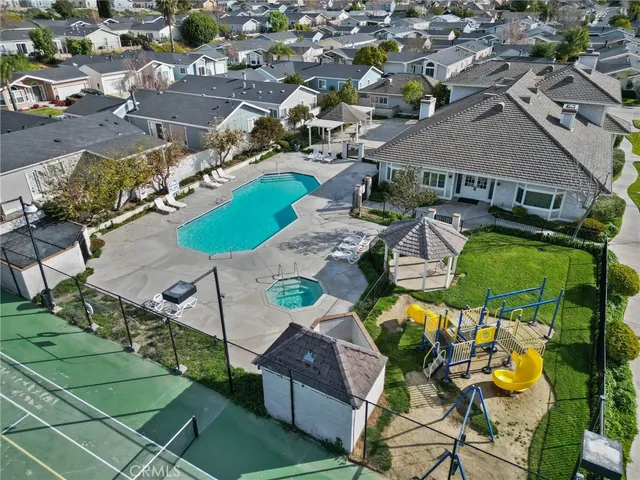 an aerial view of a house with swimming pool and outdoor seating