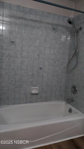 a bathroom with a shower and a bathtub
