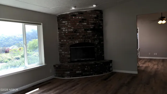 a room with wooden floor and a fireplace