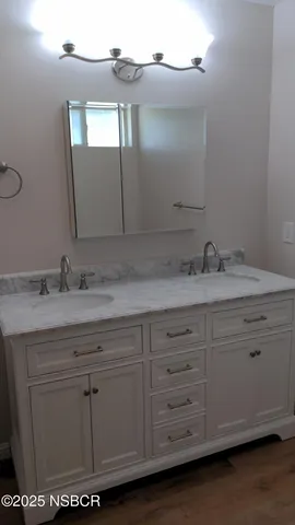 a bathroom with a sink mirror and vanity