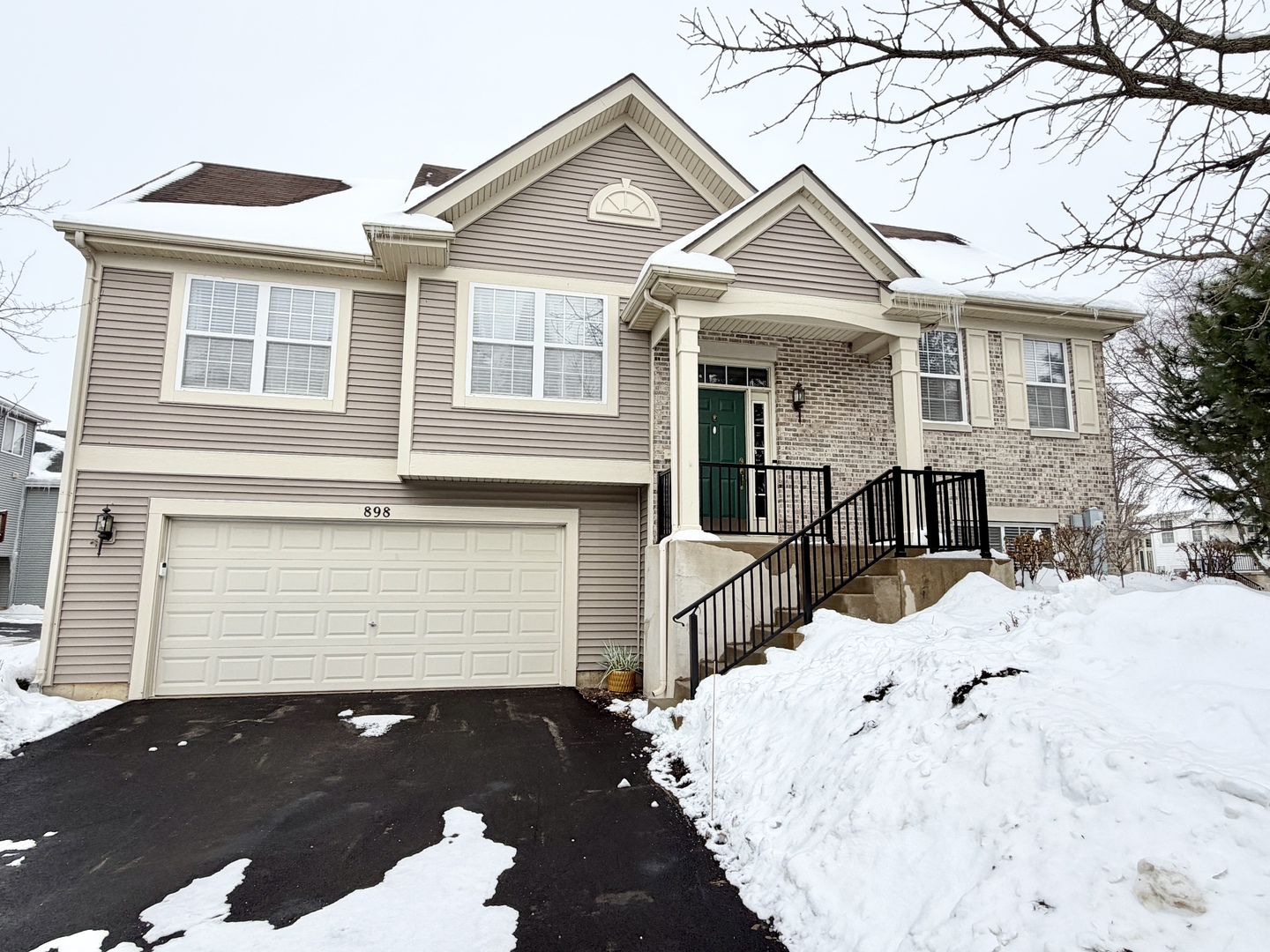 898 Emerald Drive Pingree Grove, IL 60140 - Photo 1 of 23 a front view of a house with a yard covered in snow