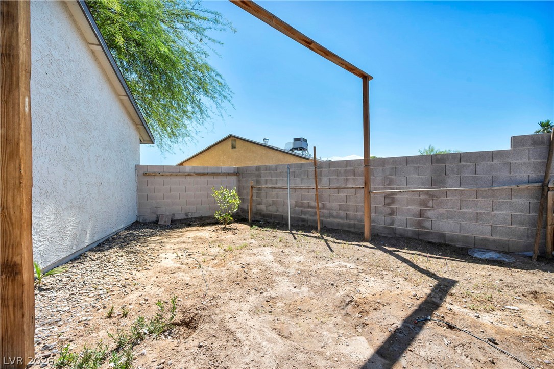 5882 Rio Tinto Way Las Vegas, NV 89110 - Photo 50 of 56 A spacious backyard enclosed by a durable block wall, ready for personalized landscaping visions.