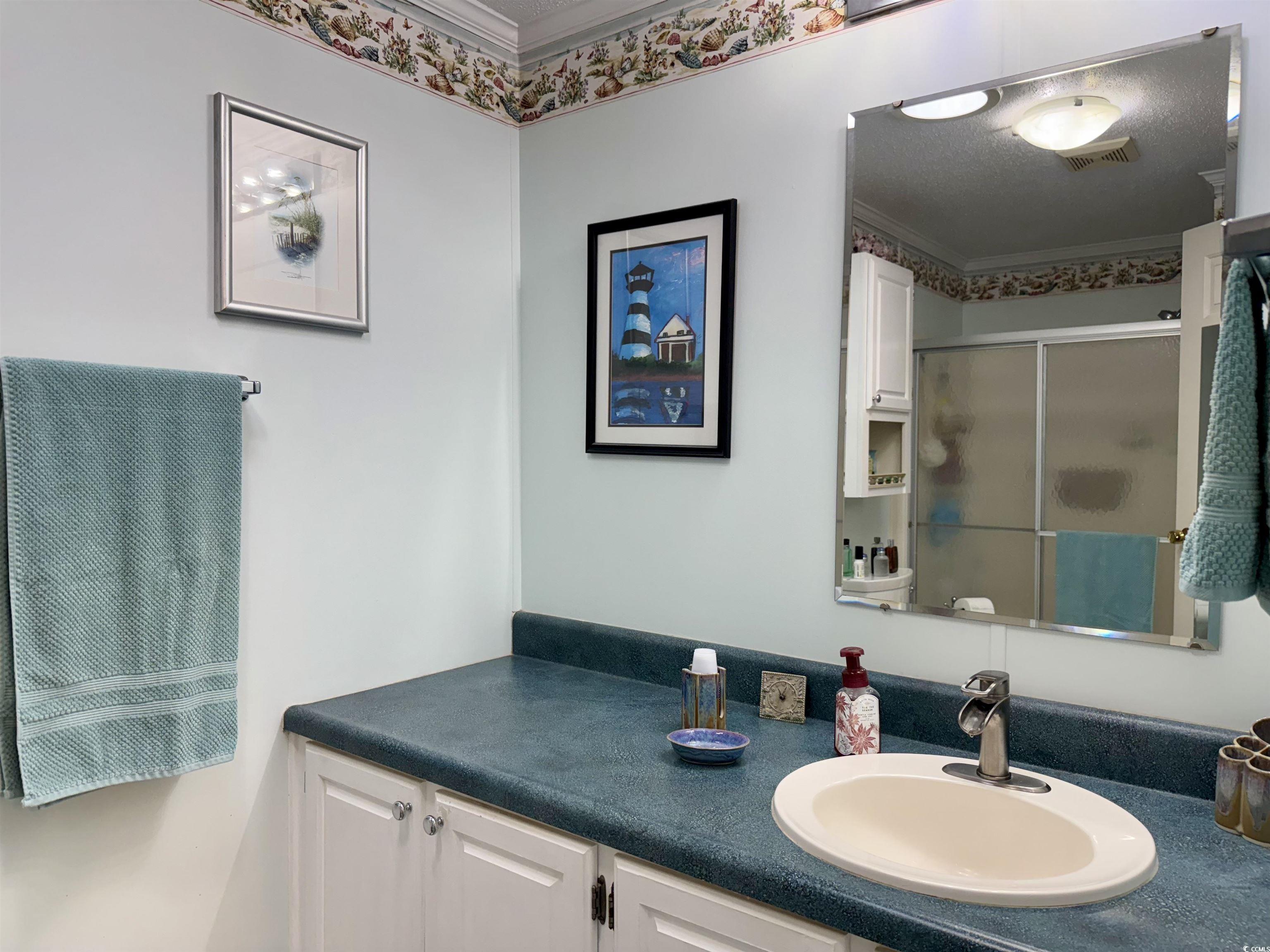 1506 Mason Circle Surfside Beach, SC 29575 - Photo 10 of 33 Full bathroom featuring vanity, a stall shower, and ornamental molding