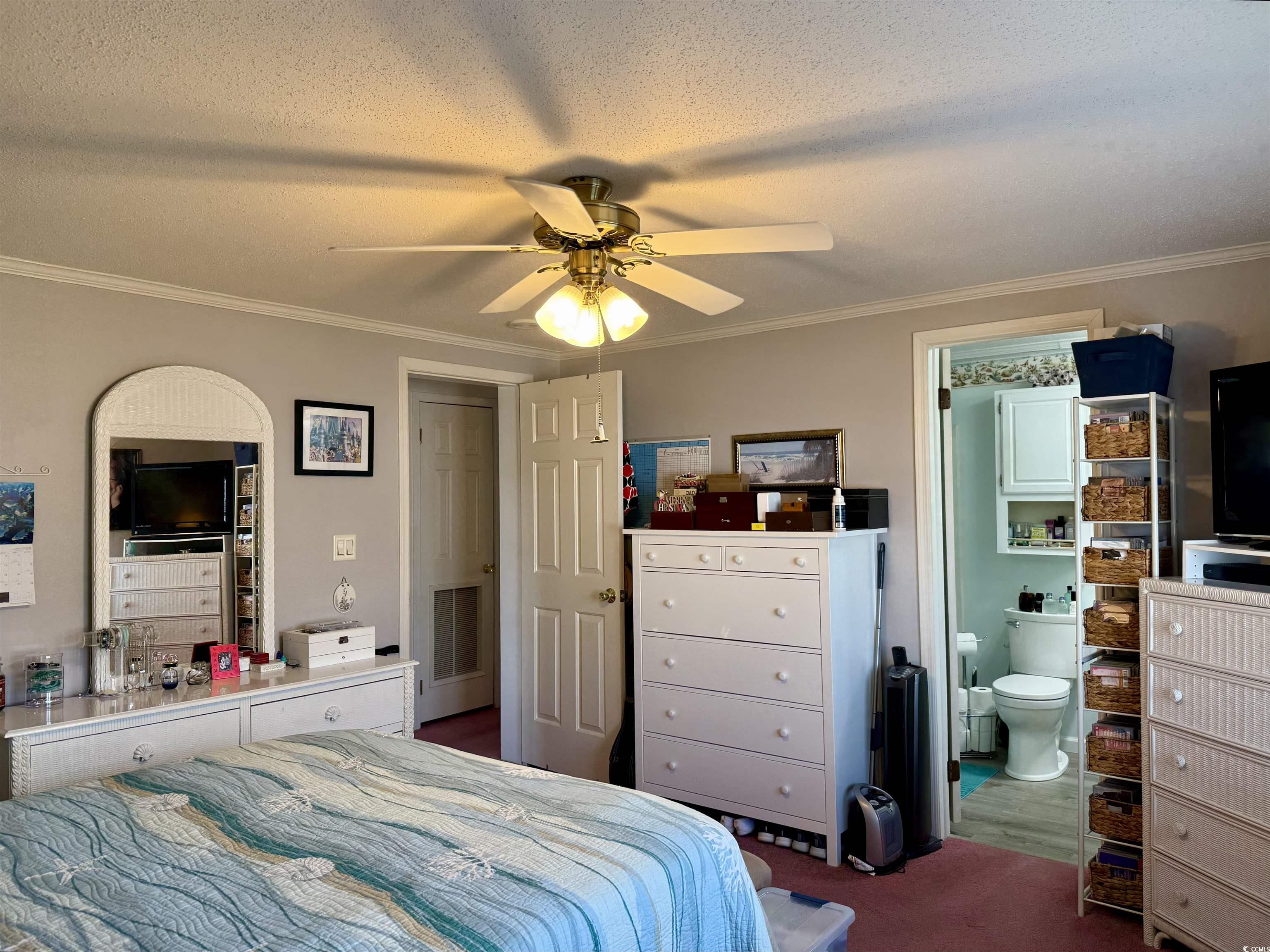 1506 Mason Circle Surfside Beach, SC 29575 - Photo 12 of 33 Bedroom with crown molding, a textured ceiling, ceiling fan, and connected bathroom