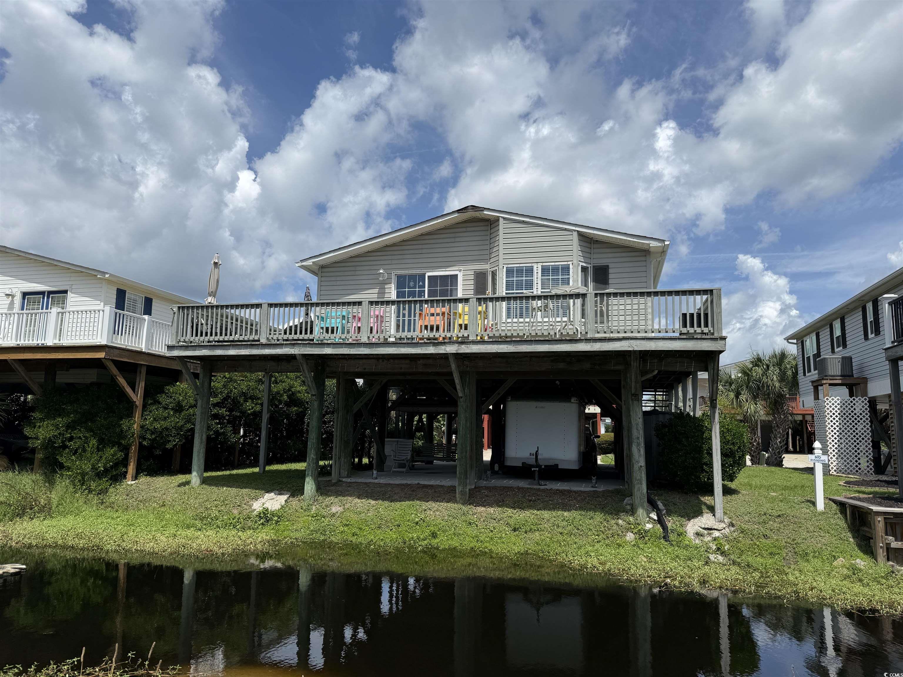 1506 Mason Circle Surfside Beach, SC 29575 - Photo 22 of 33 Back of property with a deck with water view, a carport, and stairway