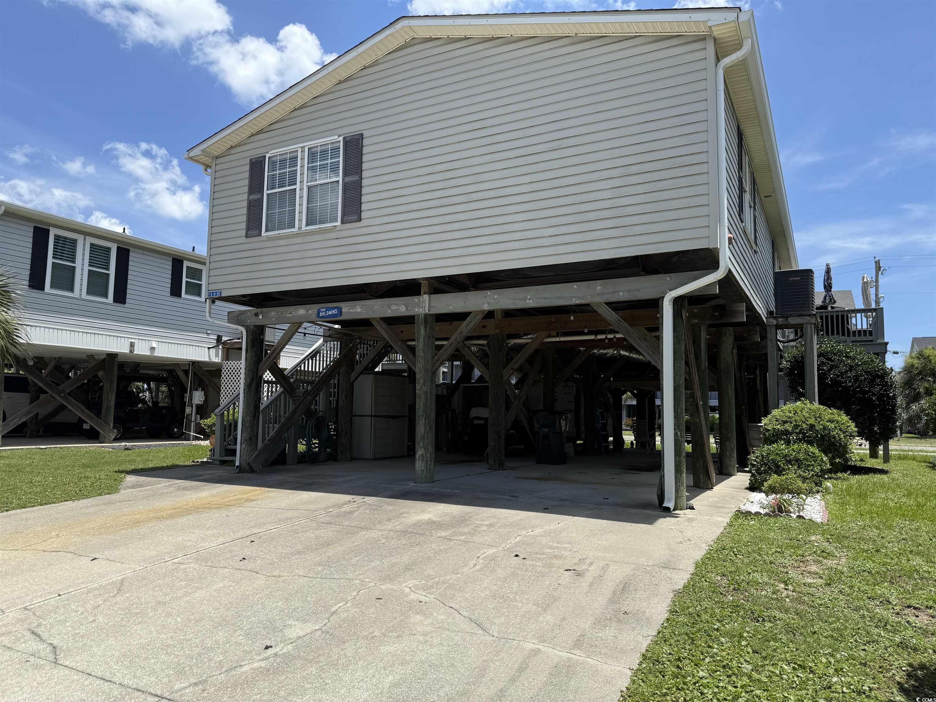 1506 Mason Circle Surfside Beach, SC 29575 - Photo 24 of 33 View of side of property featuring a carport, driveway, and stairs