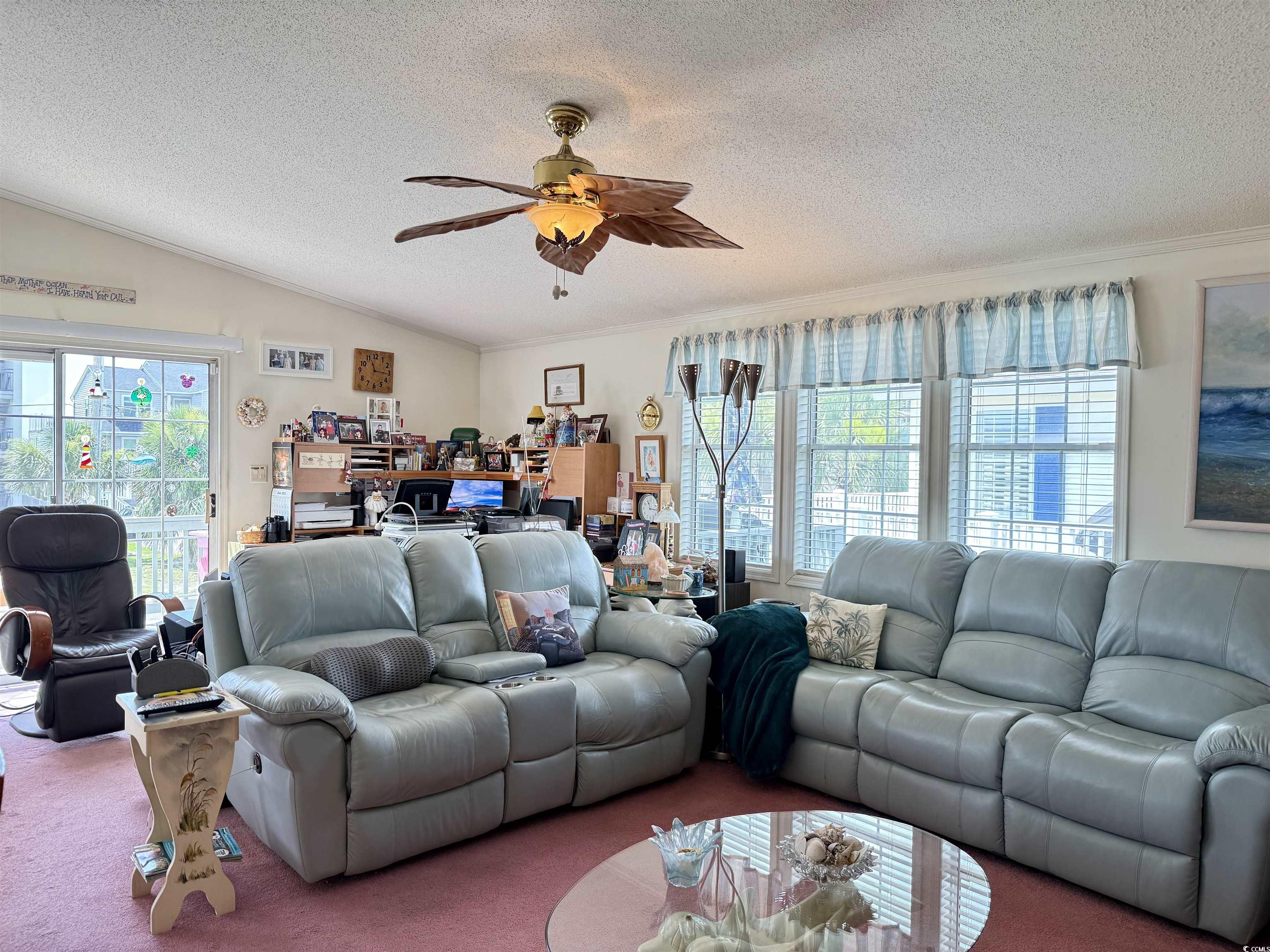 1506 Mason Circle Surfside Beach, SC 29575 - Photo 8 of 33 Carpeted living area featuring a textured ceiling, healthy amount of natural light, ceiling fan, crown molding, and vaulted ceiling