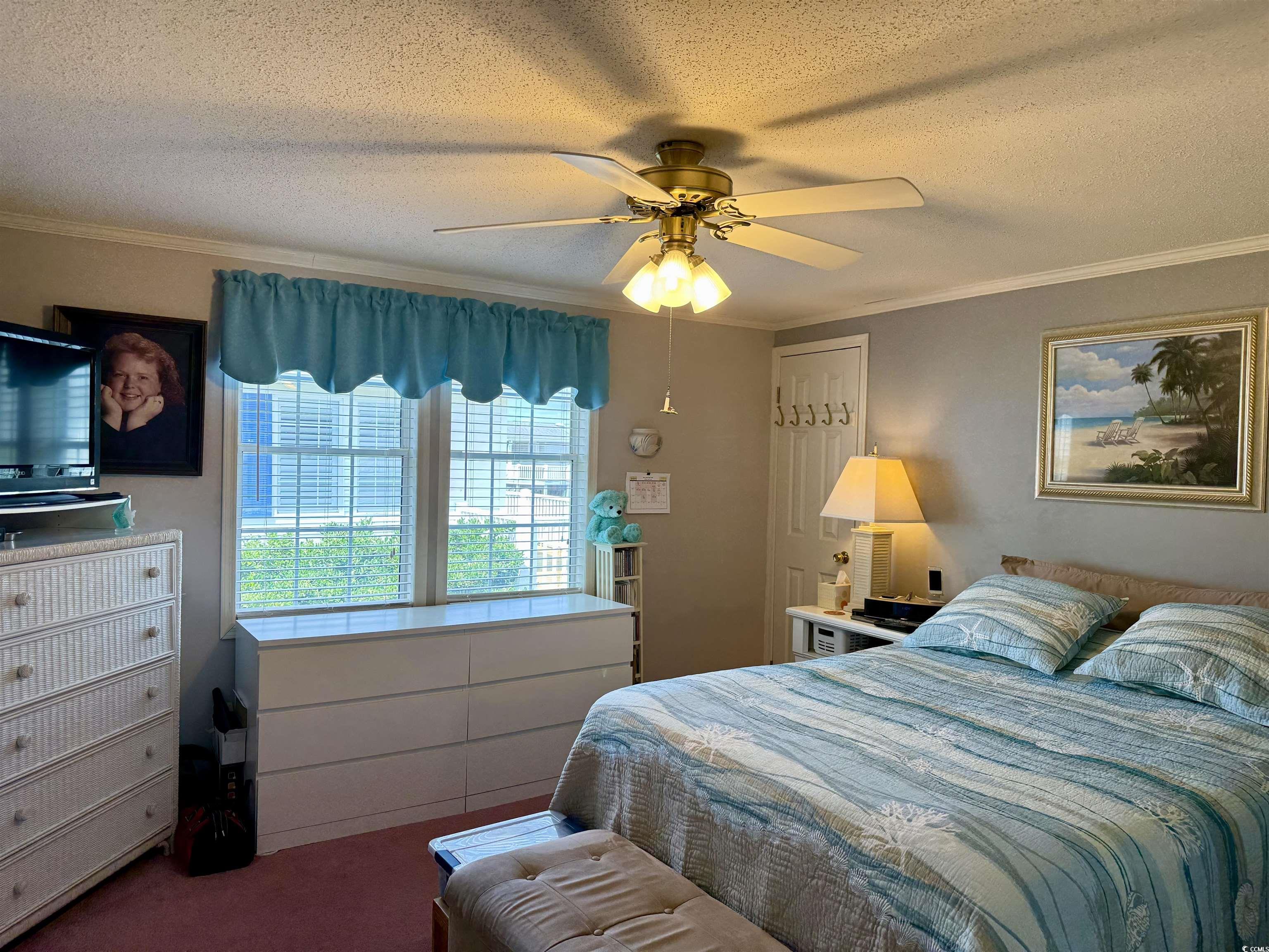 1506 Mason Circle Surfside Beach, SC 29575 - Photo 9 of 33 Bedroom featuring a textured ceiling, crown molding, carpet, and a ceiling fan