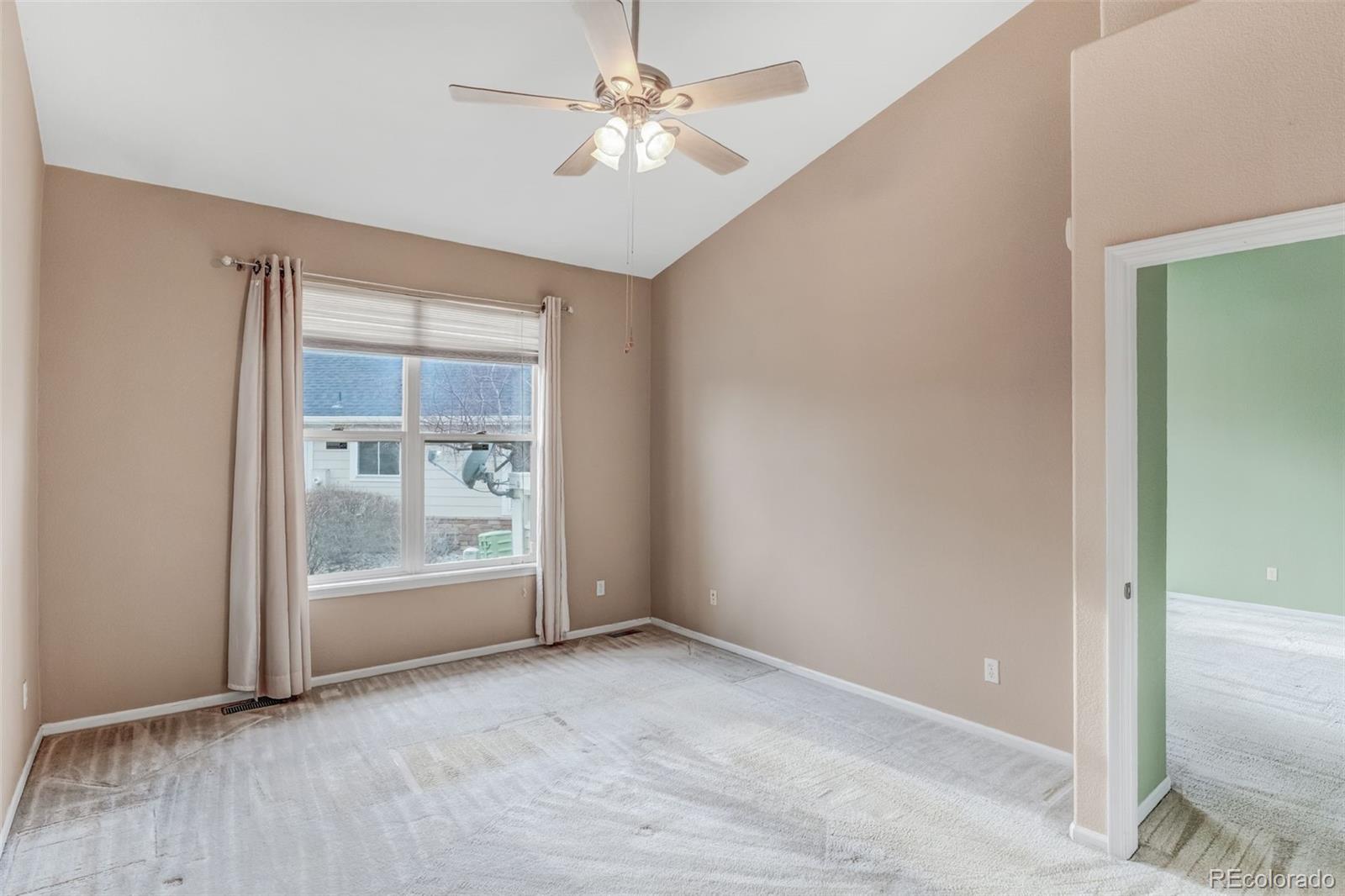 6656 South Reed Way, Unit B Littleton, CO 80123 - Photo 11 of 32 an empty room with fan and windows