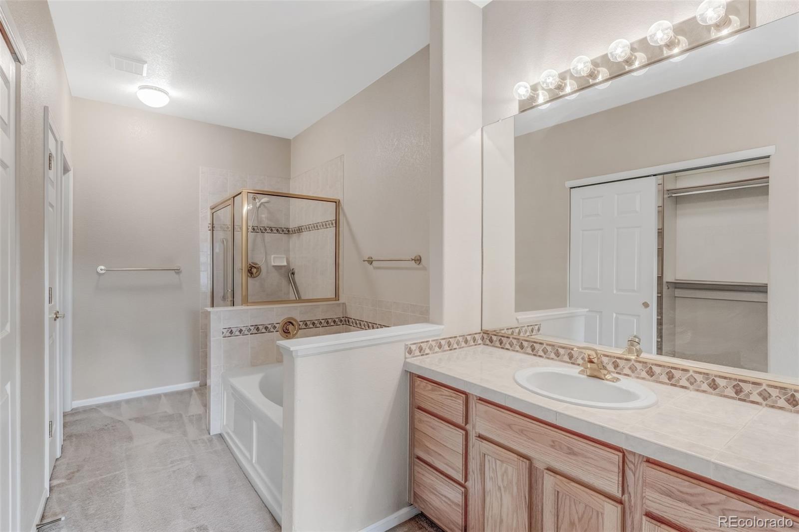 6656 South Reed Way, Unit B Littleton, CO 80123 - Photo 15 of 32 a bathroom with a sink and a mirror