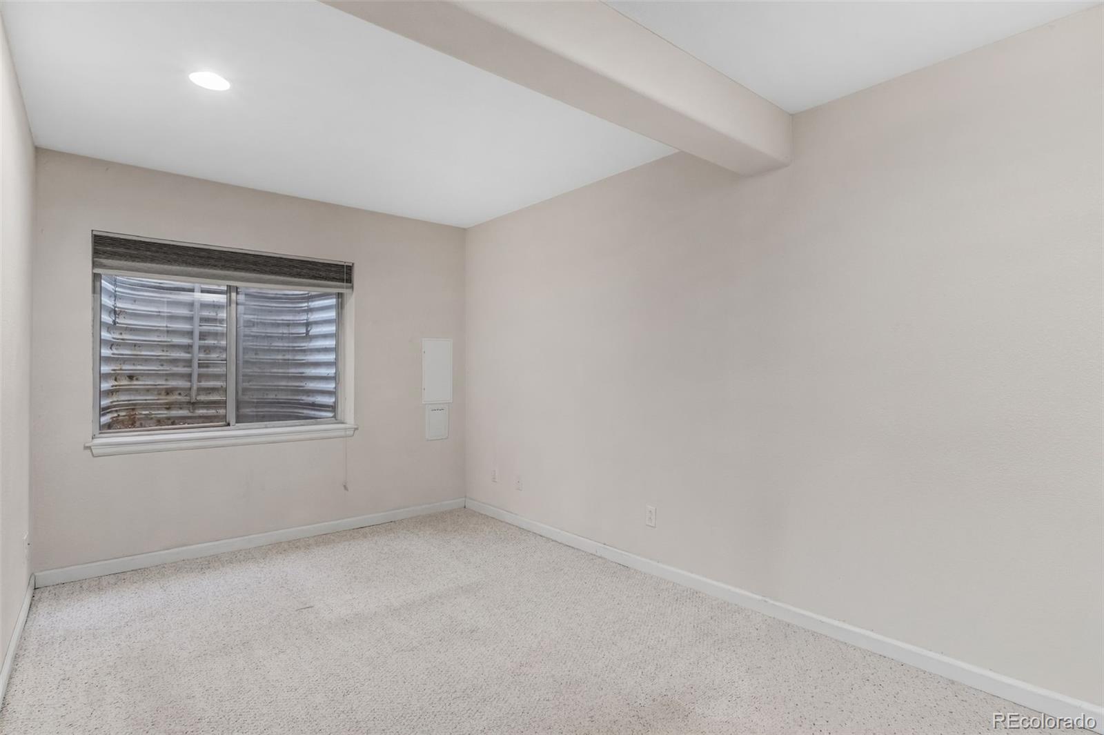 6656 South Reed Way, Unit B Littleton, CO 80123 - Photo 24 of 32 an empty room with a window