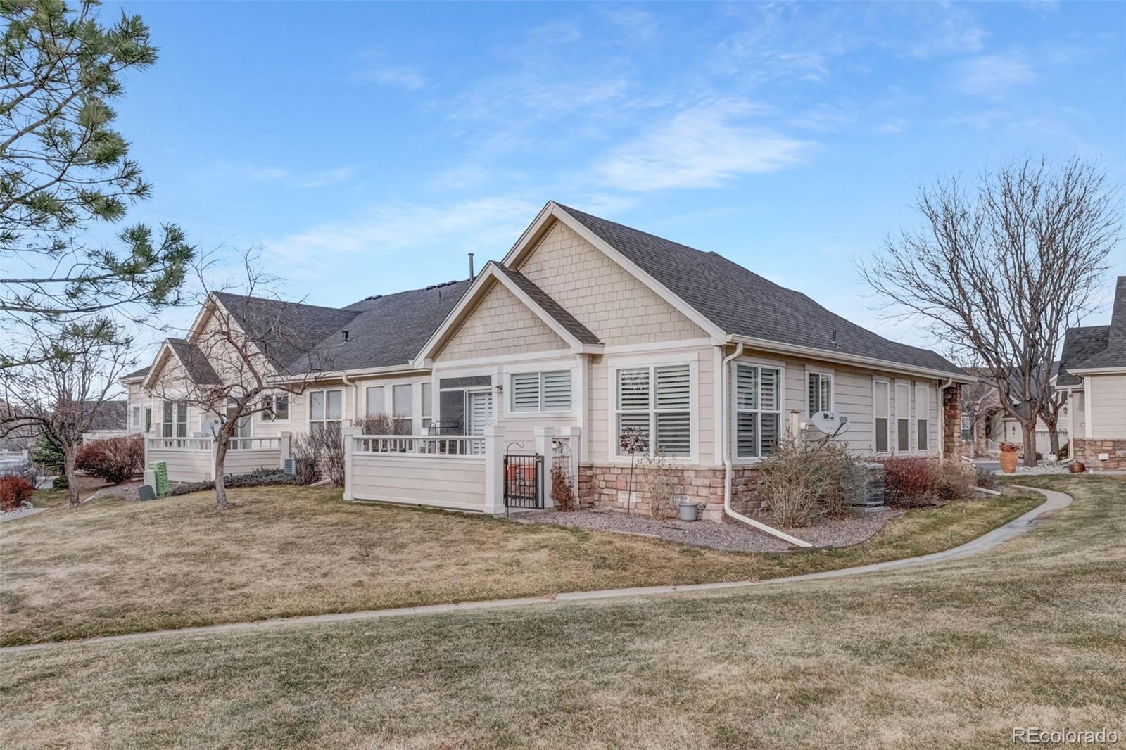 6656 South Reed Way, Unit B Littleton, CO 80123 - Photo 31 of 32 a front view of a house with a yard