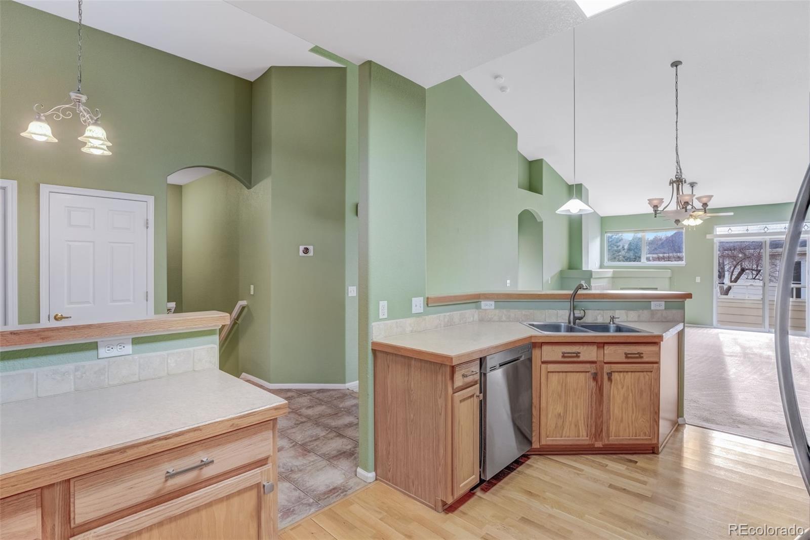 6656 South Reed Way, Unit B Littleton, CO 80123 - Photo 8 of 32 a kitchen with a sink a stove and cabinets
