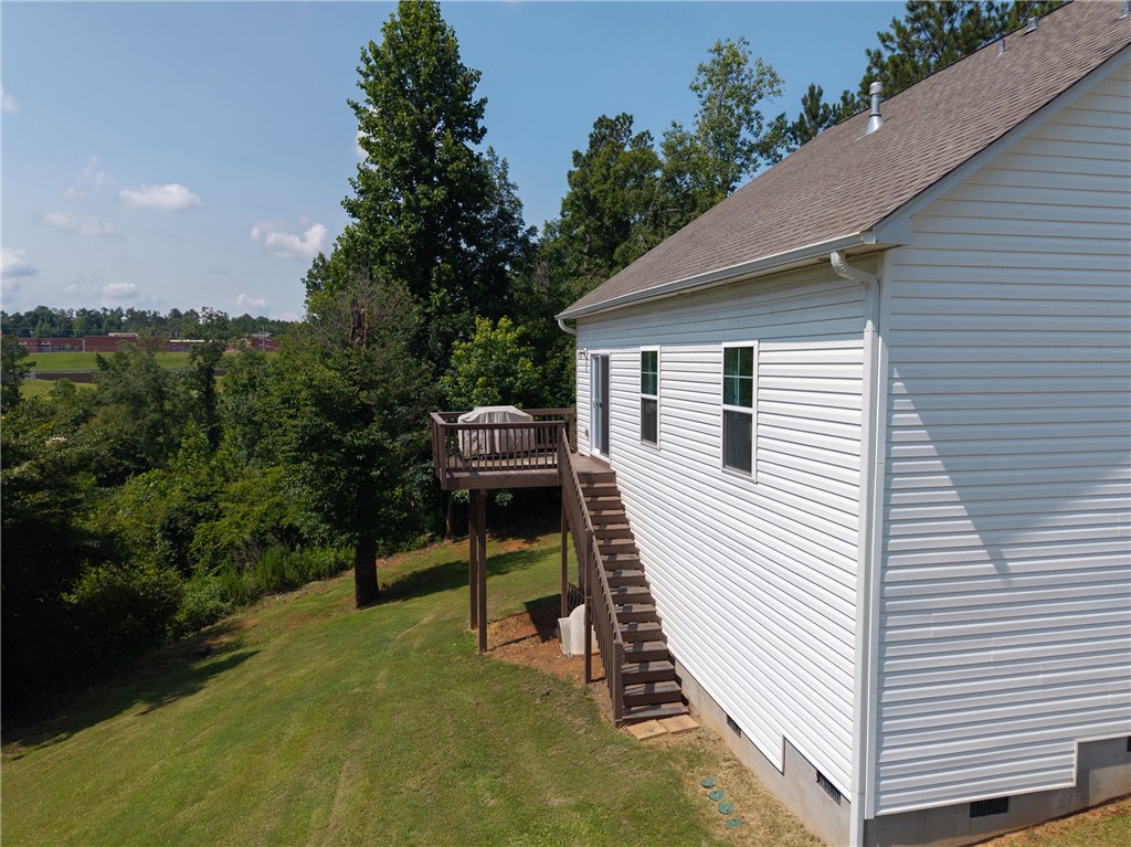768 Rocky Ridge Circle Seneca, SC 29678 - Photo 28 of 30 A spacious wooden deck extends from this residence, providing a vantage point over the verdant landscape.