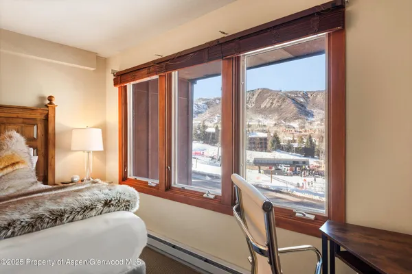 a bedroom with a large window and a bed