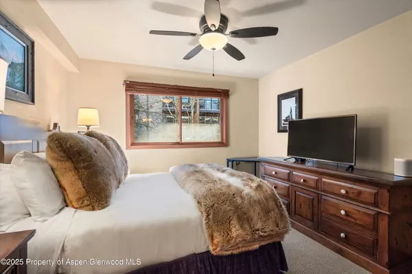 a bedroom with a bed and a flat screen tv