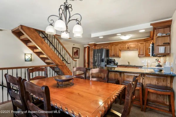 a dining room with furniture a rug and wooden floor