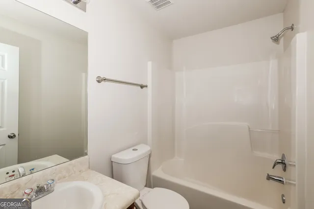 a bathroom with a sink and toilet