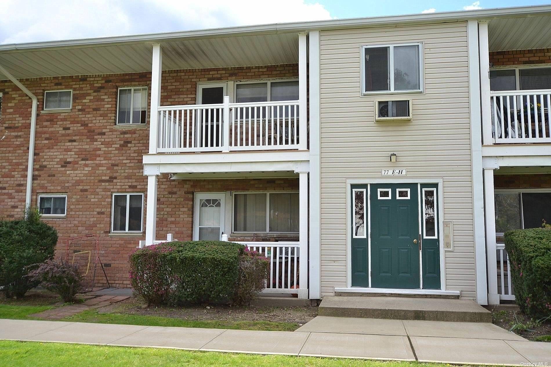 77 Adams Road, Unit 2E Central Islip, NY 11722 - Photo 1 of 1 a front view of a house with a garden