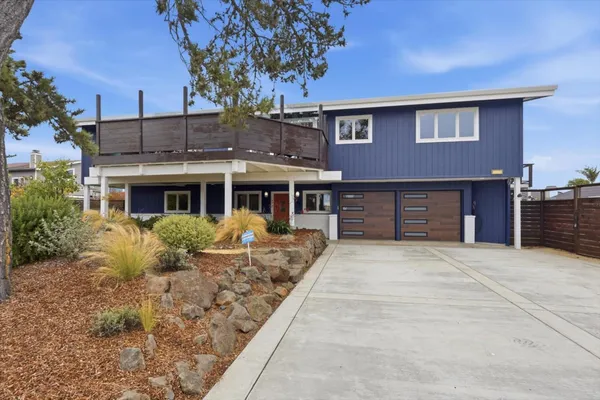 a front view of house with yard space and balcony