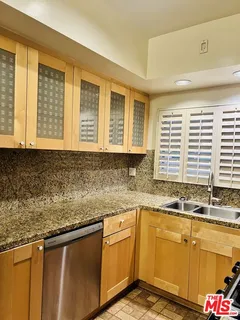 a kitchen with granite countertop a sink and a window