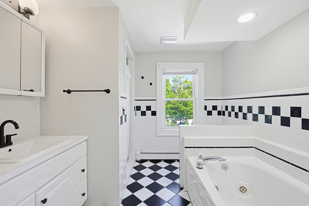 345 Sherman Street Canton, MA 02021 - Photo 31 of 42 a bathroom with a bathtub and a sink