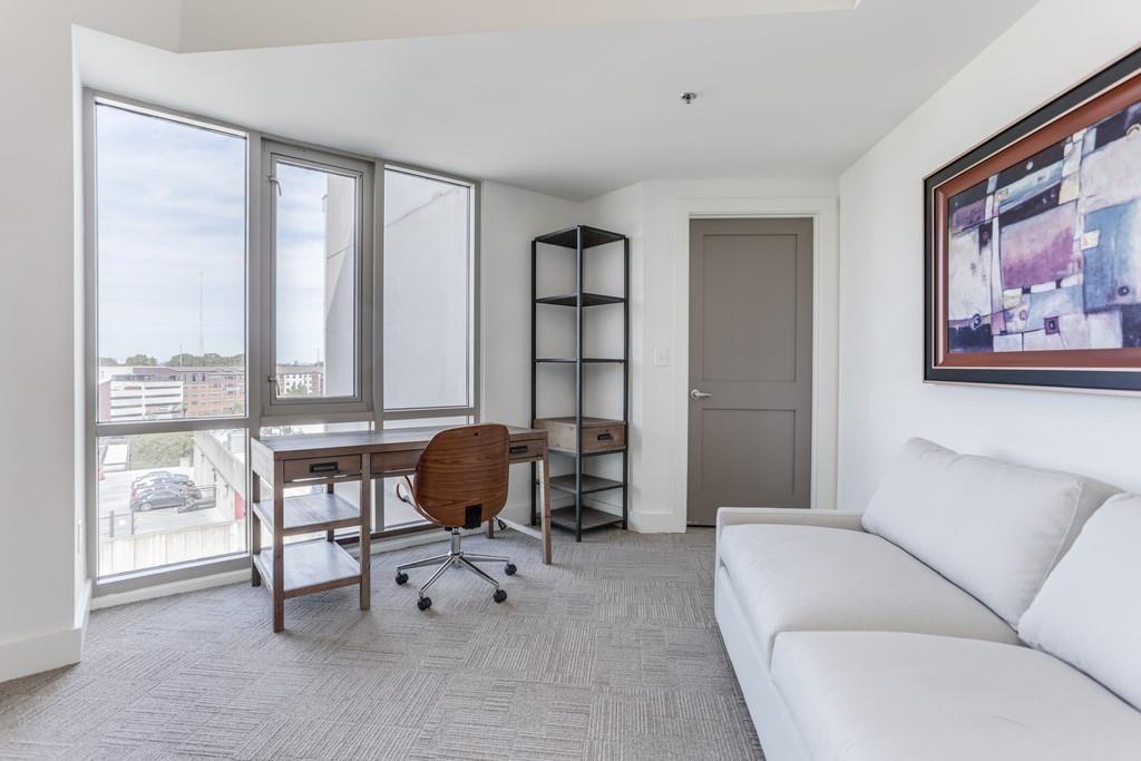 1100 Howell Mill Road Northwest, Unit 917 Atlanta, GA 30318 - Photo 11 of 22 a living room with furniture and a floor to ceiling window