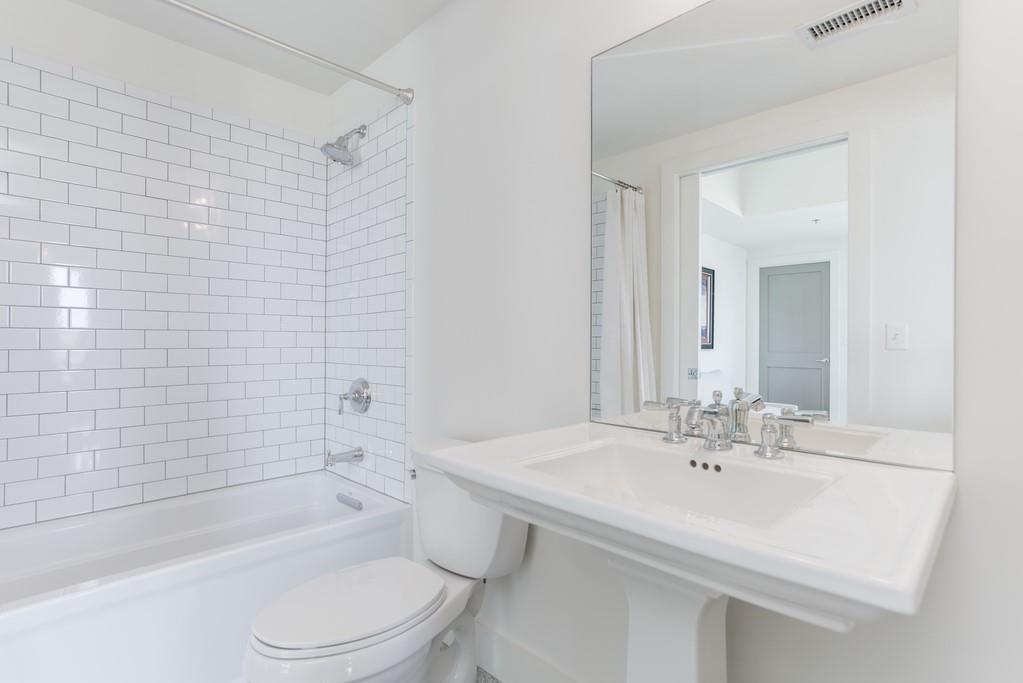 1100 Howell Mill Road Northwest, Unit 917 Atlanta, GA 30318 - Photo 13 of 22 a bathroom with a sink toilet and shower