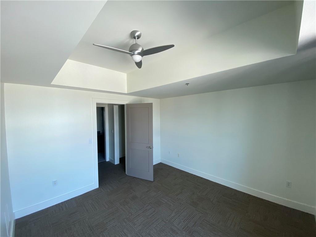 1100 Howell Mill Road Northwest, Unit 917 Atlanta, GA 30318 - Photo 15 of 22 an empty room with a ceiling fan and a window