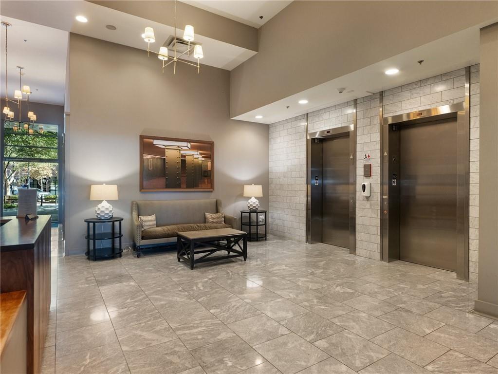 1100 Howell Mill Road Northwest, Unit 917 Atlanta, GA 30318 - Photo 18 of 22 a living room with furniture and a flat screen tv