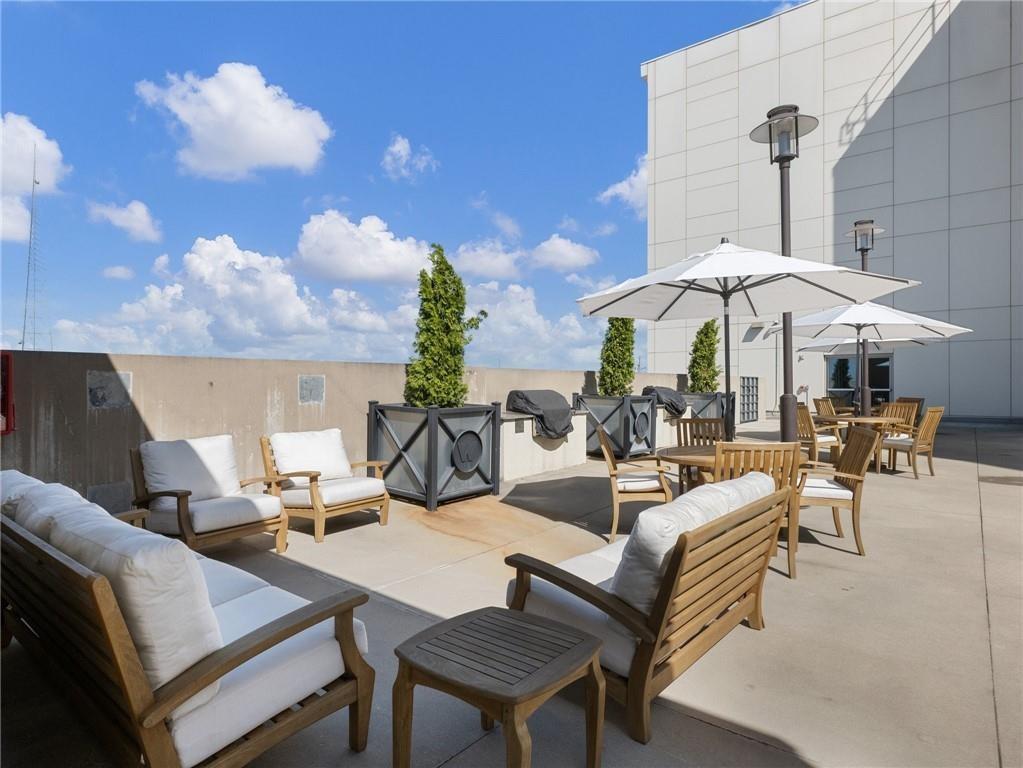 1100 Howell Mill Road Northwest, Unit 917 Atlanta, GA 30318 - Photo 19 of 22 a living room with patio furniture and a chandelier