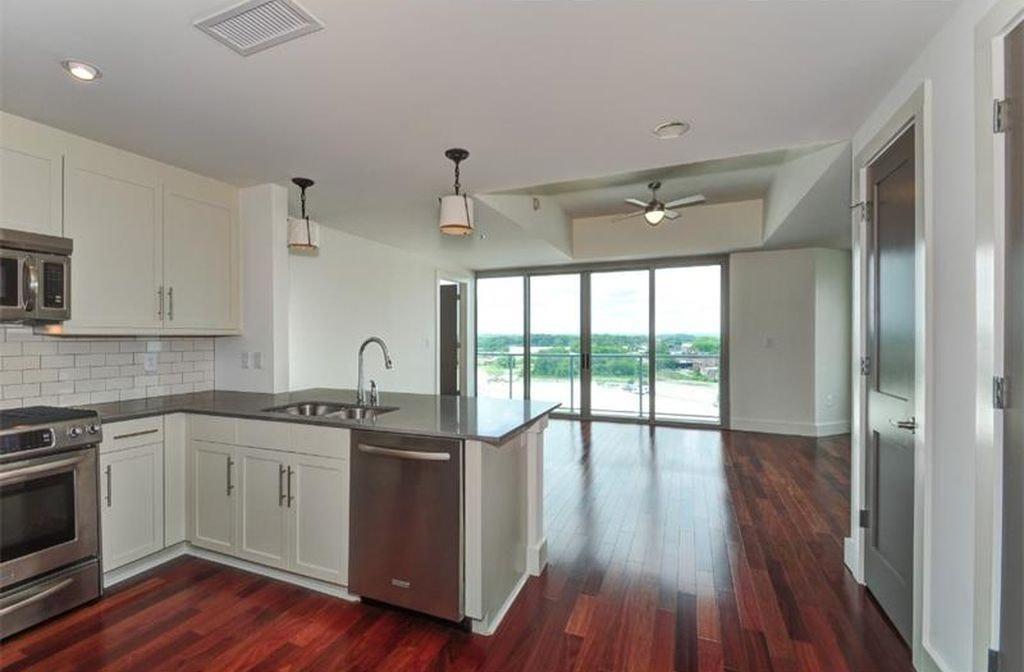 1100 Howell Mill Road Northwest, Unit 917 Atlanta, GA 30318 - Photo 5 of 22 a view of a kitchen with a sink and wooden floor