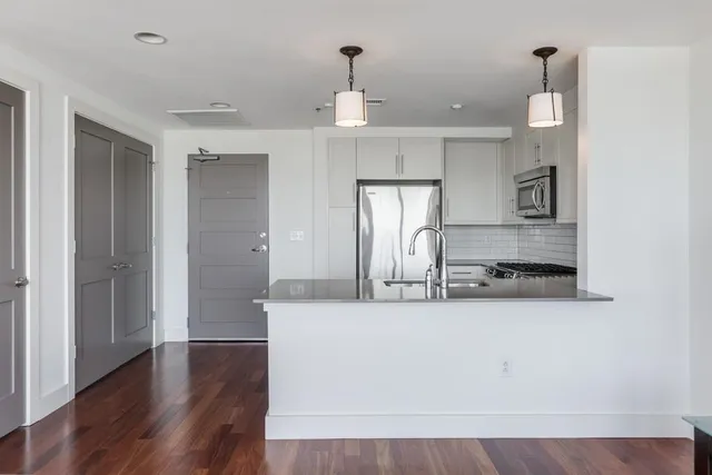 a view of a kitchen with marble kitchen and refrigerator