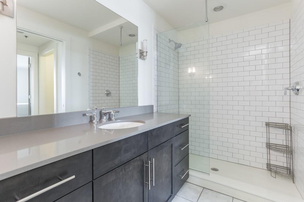 1100 Howell Mill Road Northwest, Unit 917 Atlanta, GA 30318 - Photo 10 of 22 a bathroom with a sink and a mirror