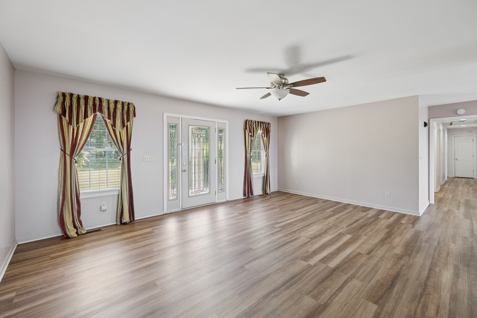7365 Rowe Gap Road Belvidere, TN 37306 - Photo 12 of 78 a view of an empty room with glass door and wooden floor
