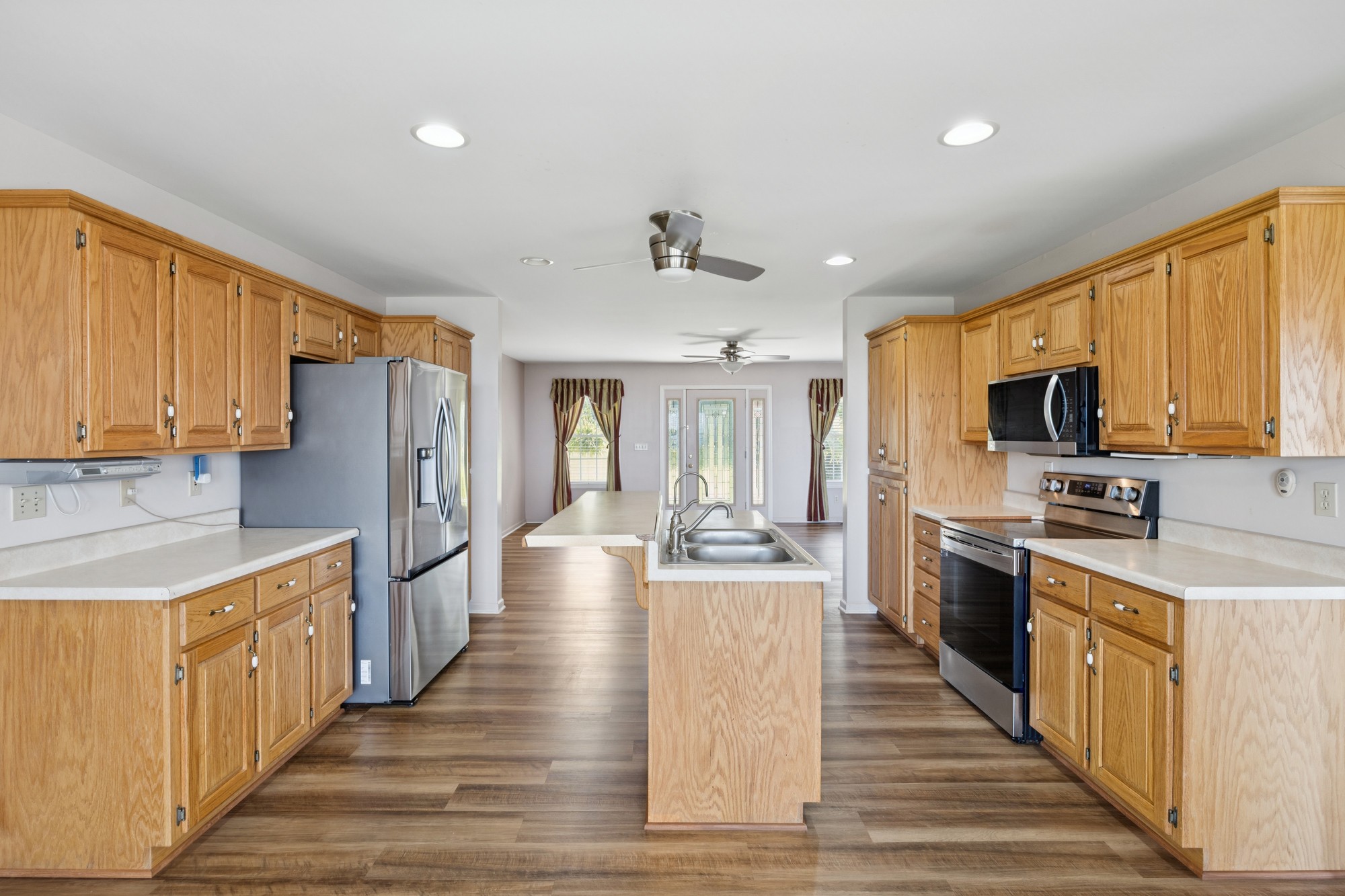 7365 Rowe Gap Road Belvidere, TN 37306 - Photo 18 of 78 a large kitchen with stainless steel appliances granite countertop a refrigerator a stove top oven a sink dishwasher and wooden cabinets with wooden floor