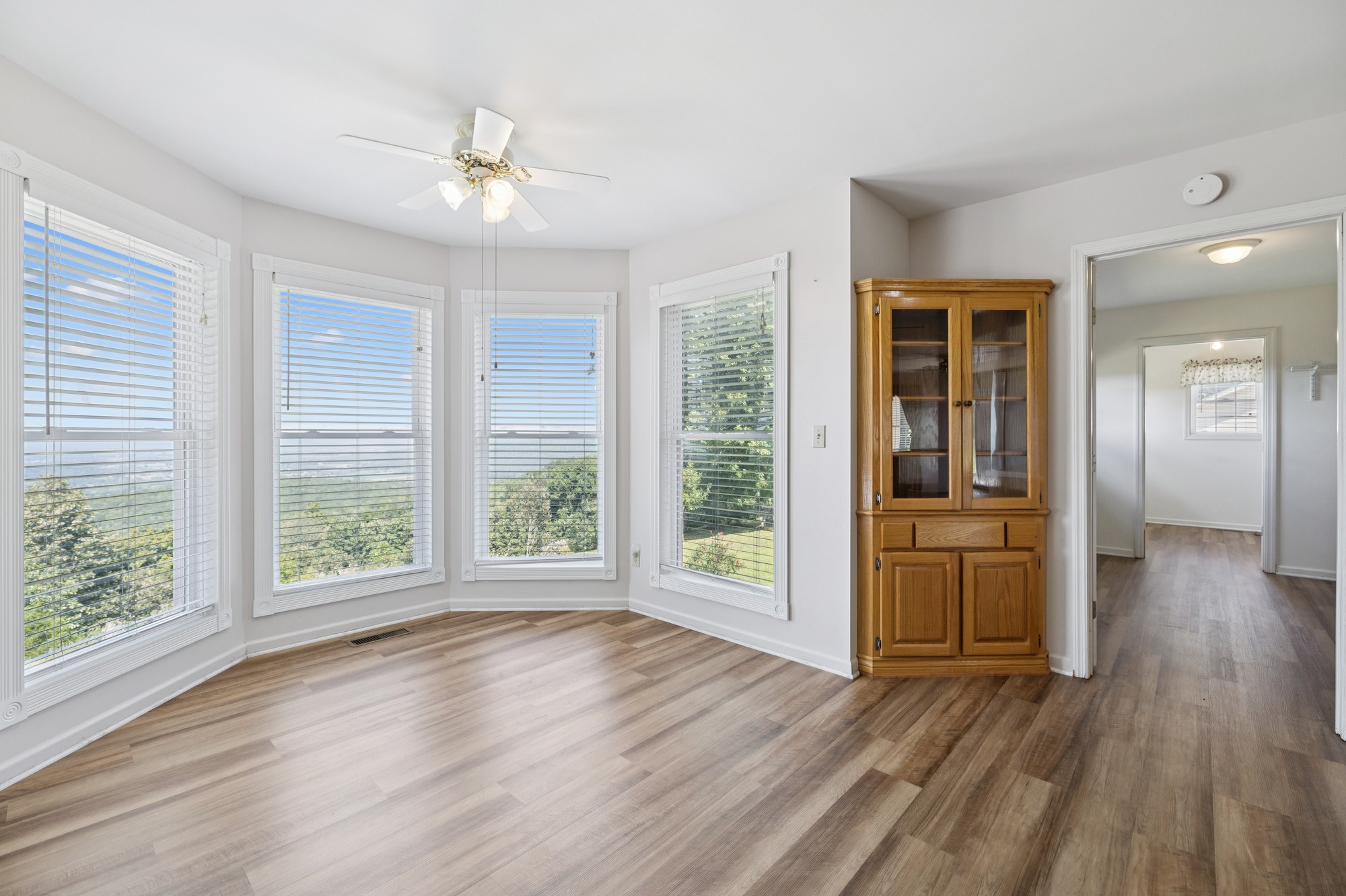 7365 Rowe Gap Road Belvidere, TN 37306 - Photo 21 of 78 a view of an empty room with wooden floor and a window