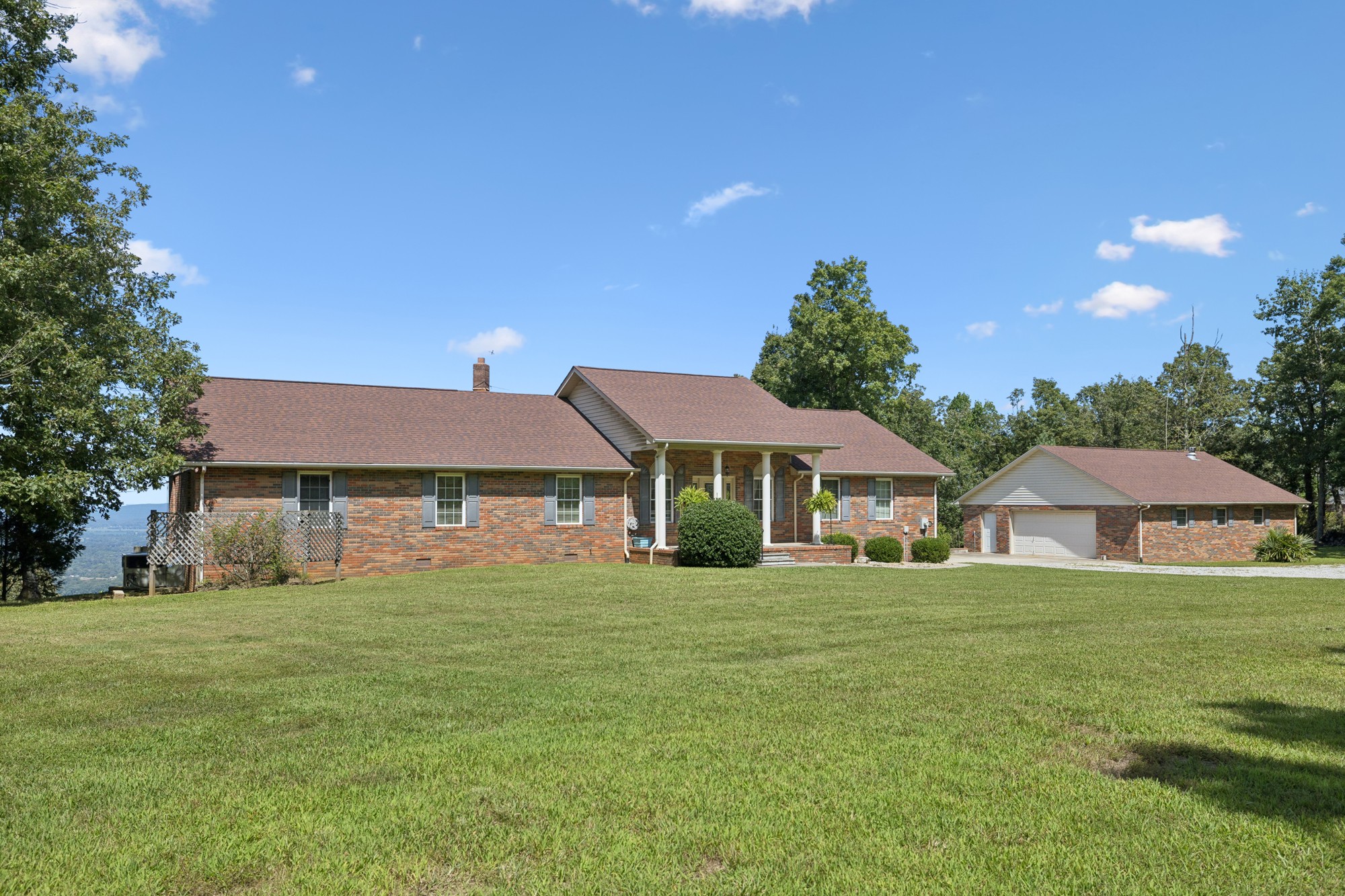 7365 Rowe Gap Road Belvidere, TN 37306 - Photo 4 of 78 a white house with a big yard and large trees