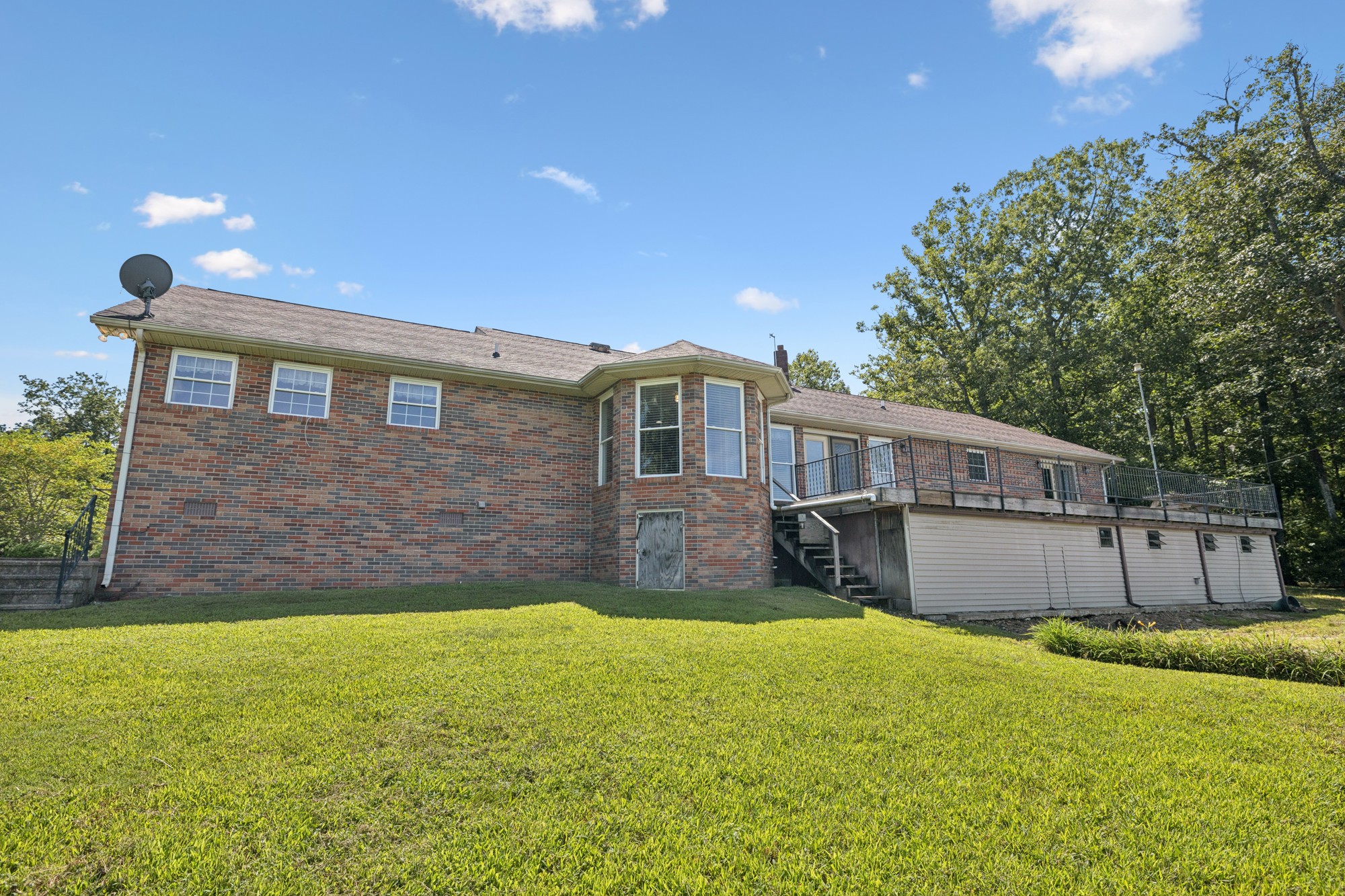 7365 Rowe Gap Road Belvidere, TN 37306 - Photo 53 of 78 a front view of a house with a yard and a large tree
