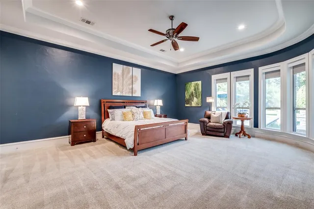 a bedroom with a bed gym equipment and a large window