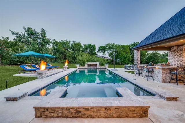 a view of a swimming pool with a patio