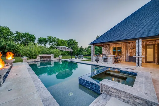 swimming pool view with a seating space