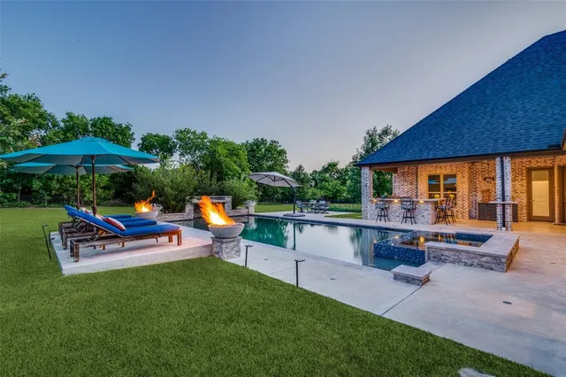 a view of a house with backyard porch and sitting area