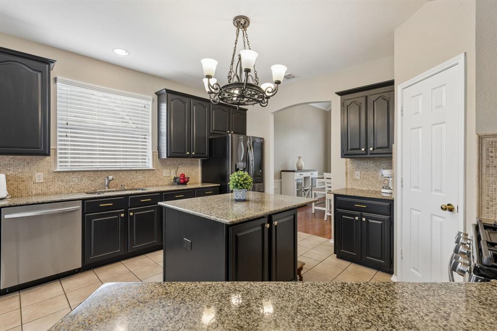 129 Timberbluff Lane Murphy, TX 75094 - Photo 11 of 34 a kitchen with stainless steel appliances granite countertop a sink stove and refrigerator