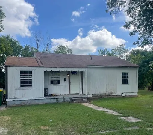 a backyard of a house with table and chairs