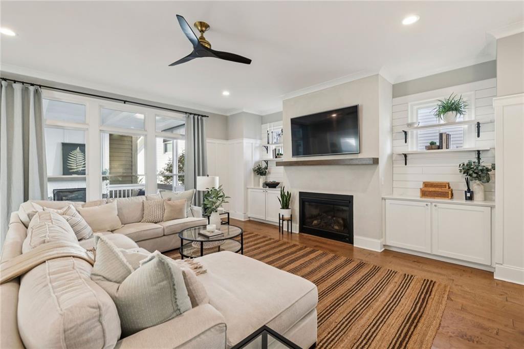 7345 Samples Field Road Cumming, GA 30040 - Photo 14 of 29 a living room with furniture a flat screen tv and a fireplace