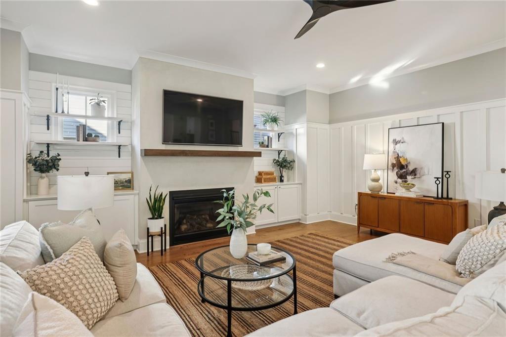 7345 Samples Field Road Cumming, GA 30040 - Photo 15 of 29 a living room with furniture and a fireplace